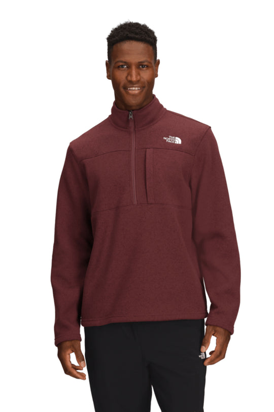 Man wearing a maroon fleece pullover with a brand logo on a white background