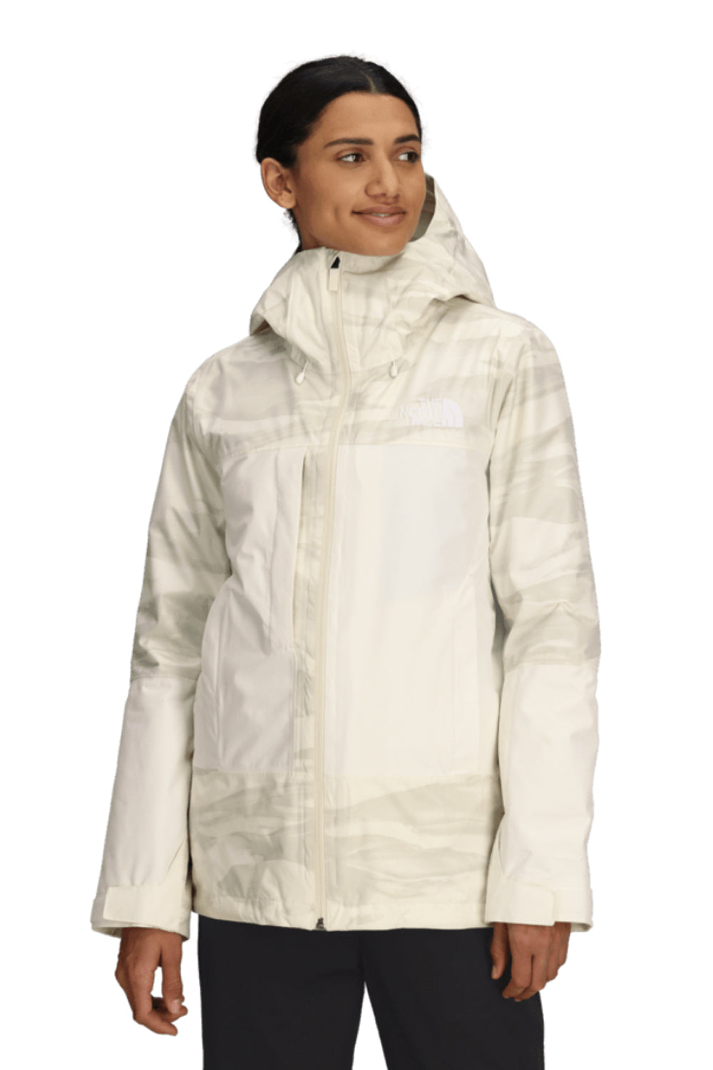 Person wearing a light-colored North Face ski jacket on a white background