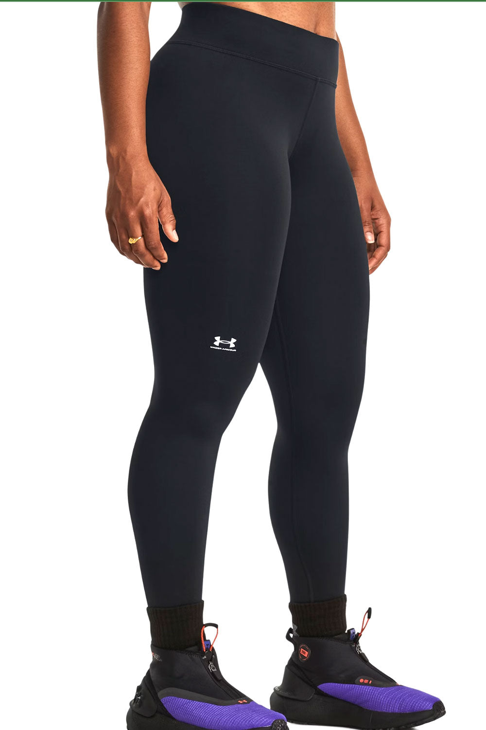 Person wearing black leggings with a brand logo on a white background