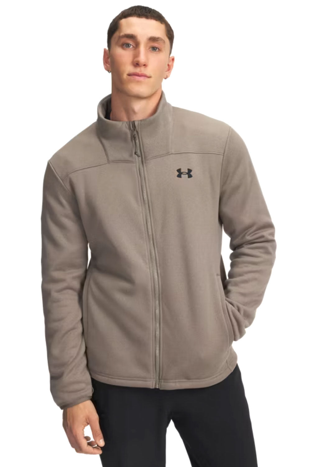 Man wearing a beige Under Armour jacket on a white background