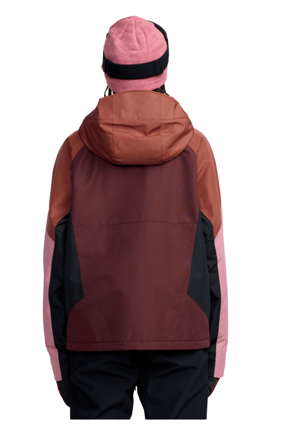 Person wearing a maroon and pink jacket with a hood on a white background