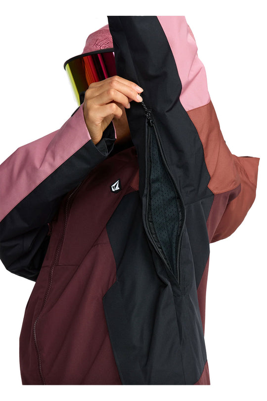 Close-up of a person adjusting the hood of a multicolored jacket with a visible brand logo.