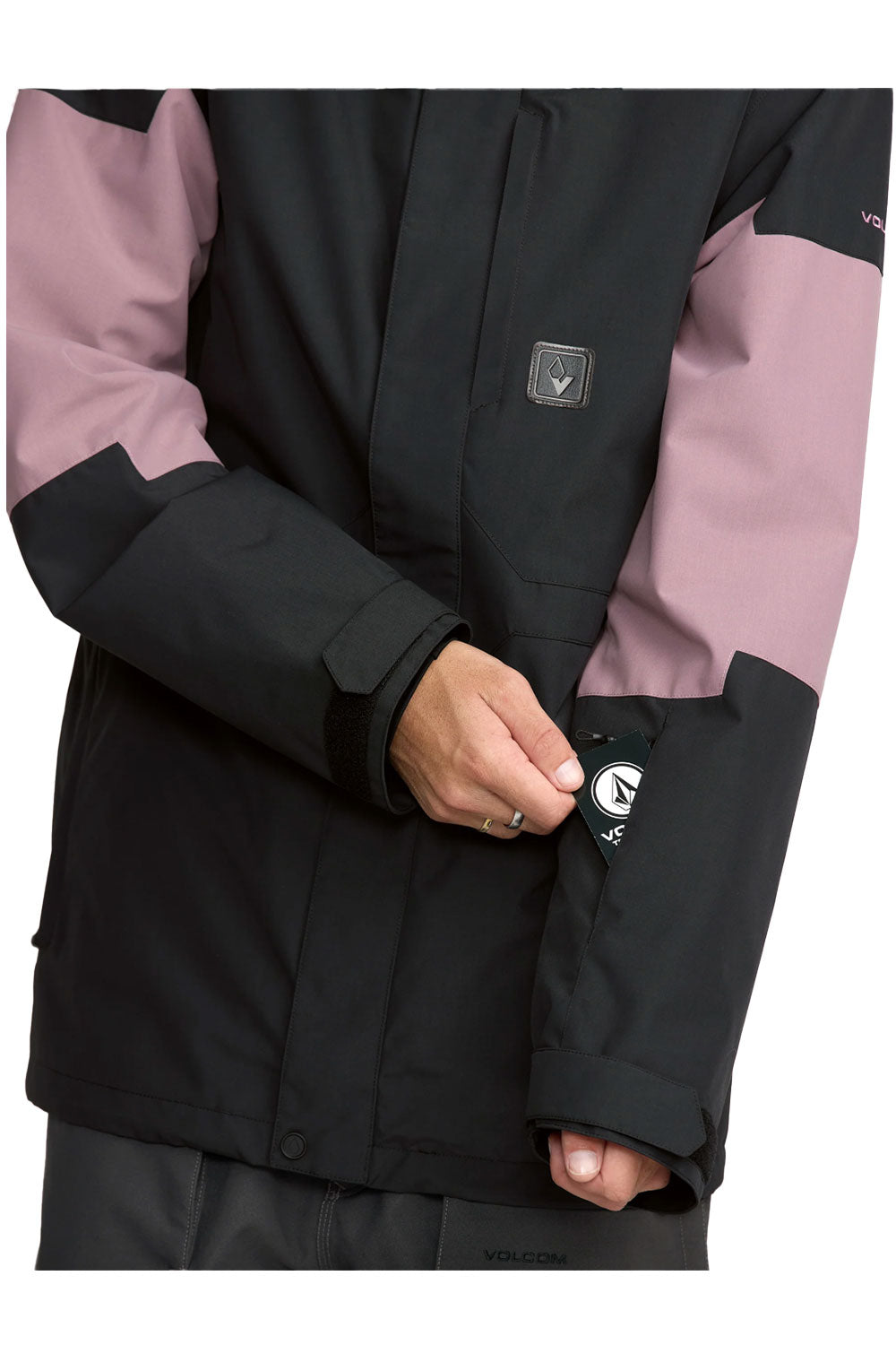 Close-up of a black and pink jacket with a brand logo on a white background
