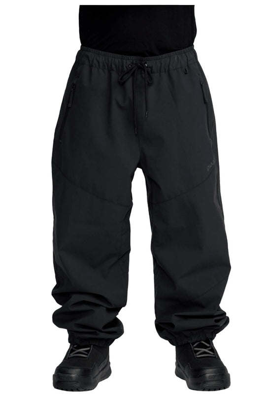 Black pants worn by a person on a white background