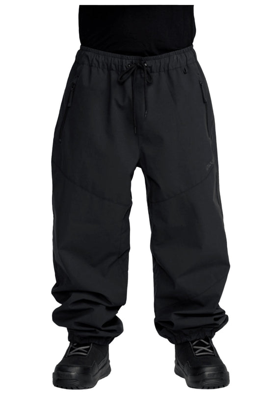 Black pants worn by a person on a white background