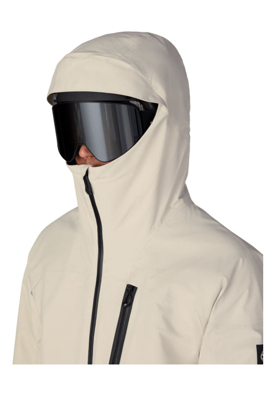 Person wearing a beige hooded jacket with a black visor on a white background