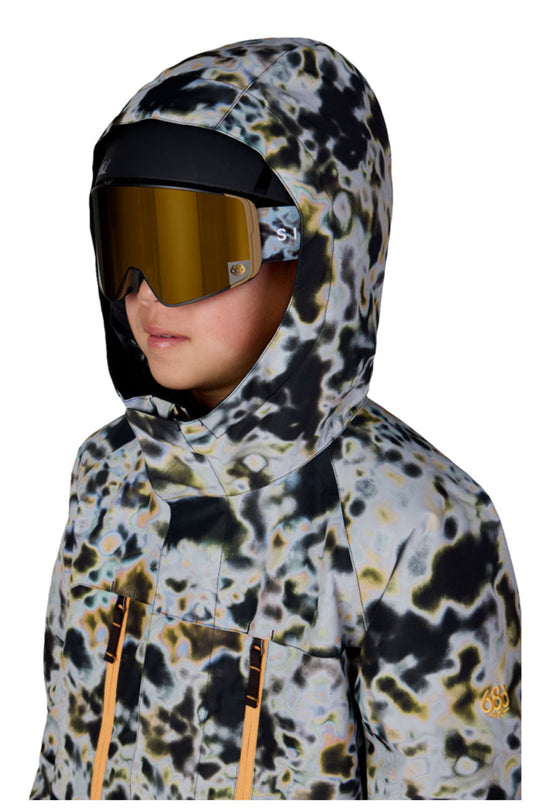 Person wearing a patterned hooded jacket with reflective goggles on a white background