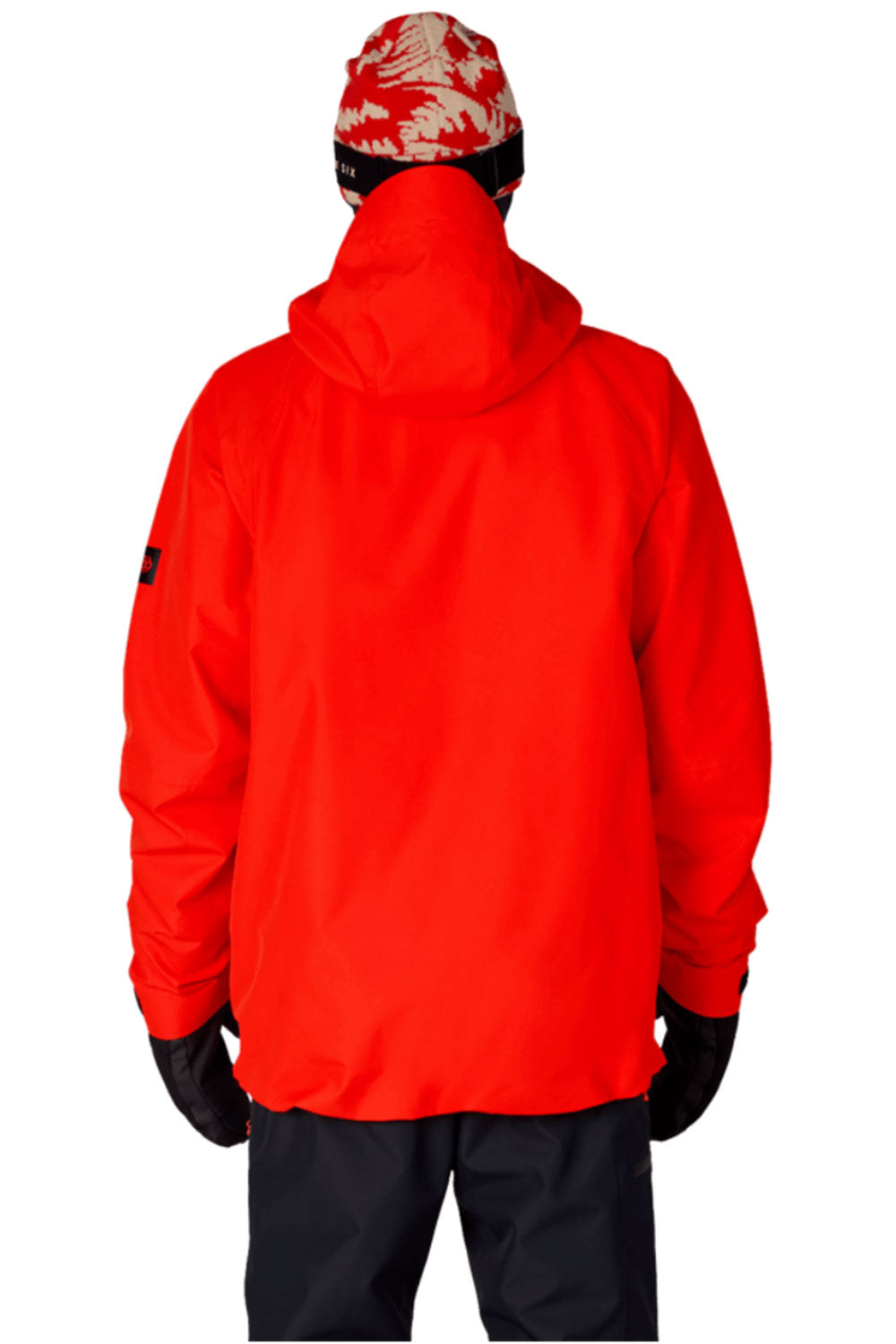 Person wearing a bright red jacket, black pants, and a patterned beanie on a white background
