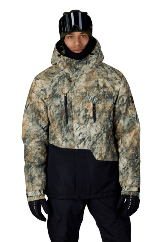 Person wearing a camouflage jacket and black pants on a white background