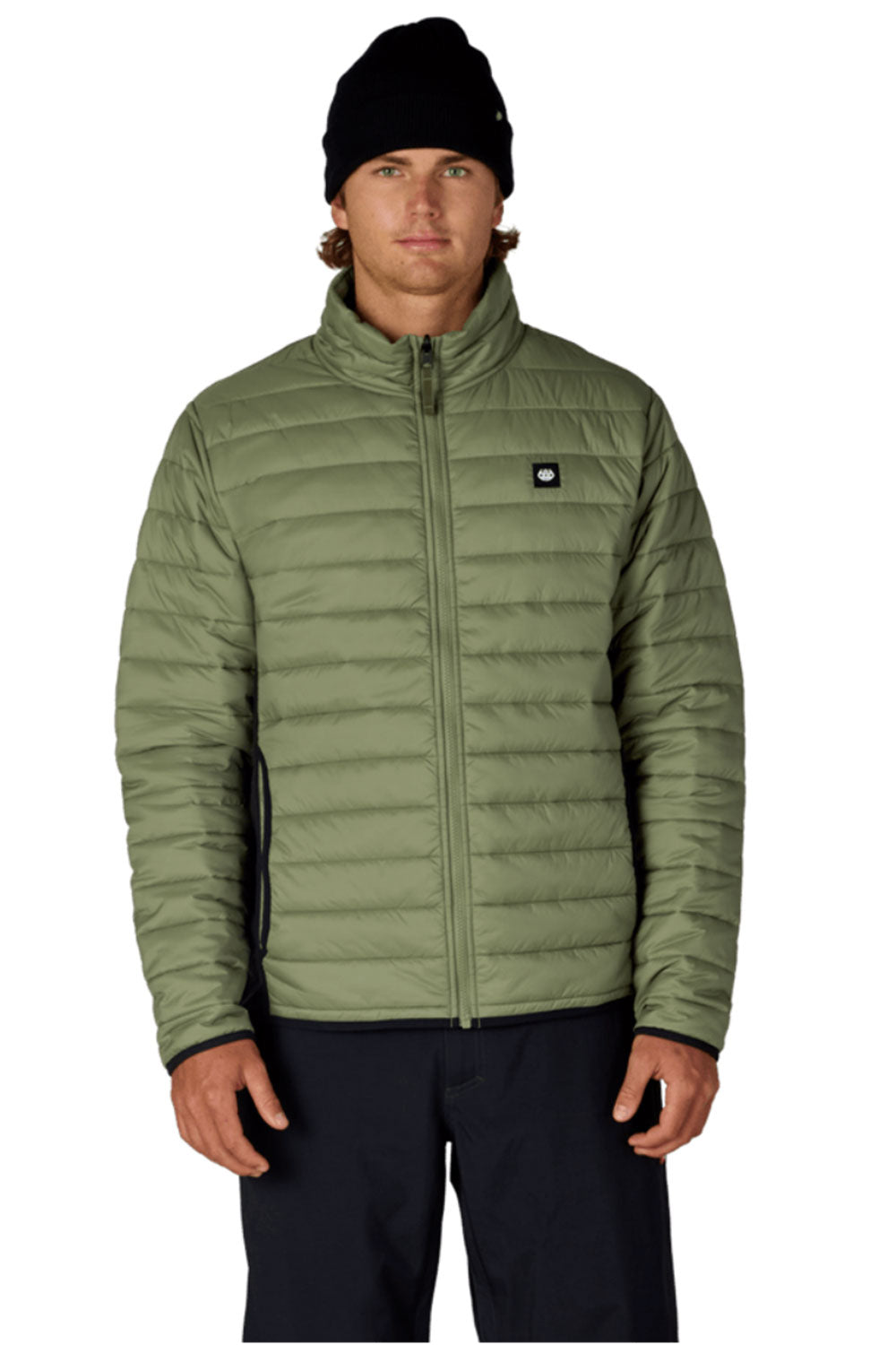 Man wearing a green puffer jacket with a brand logo on a white background