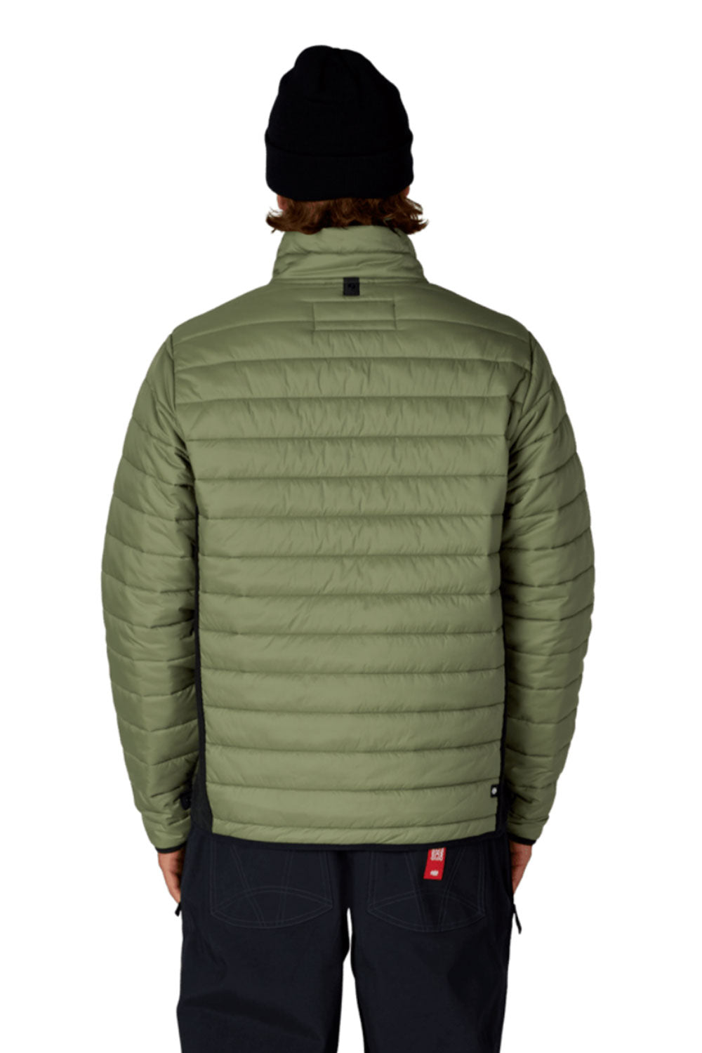 Person wearing a green puffer jacket and black beanie on a white background