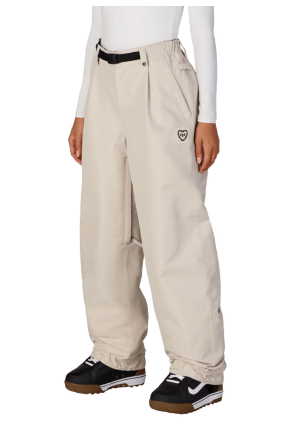 Beige snow pants worn by a person on a white background