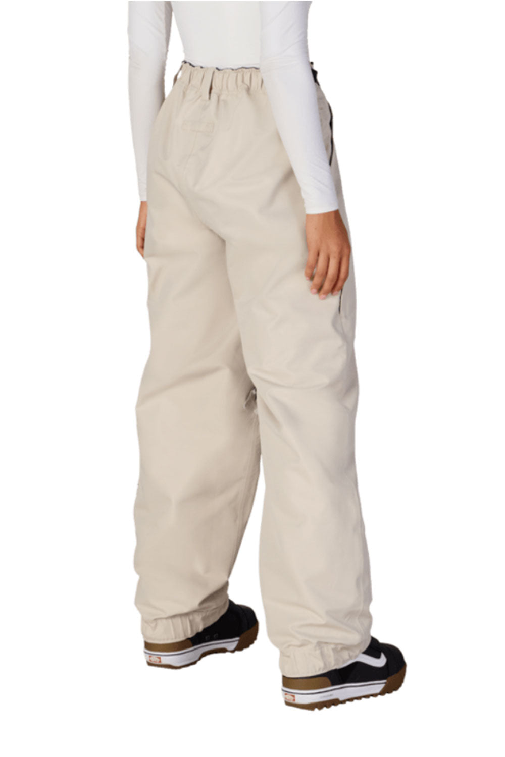 Beige snow pants worn by a person on a white background