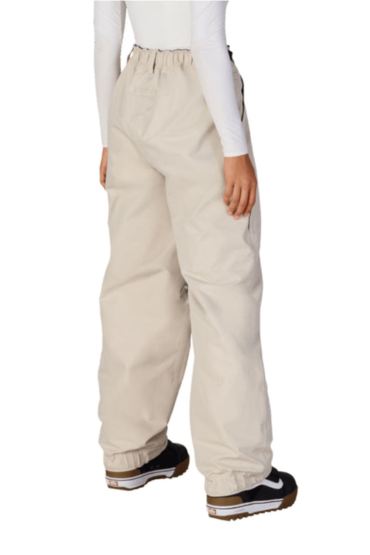 Beige snow pants worn by a person on a white background