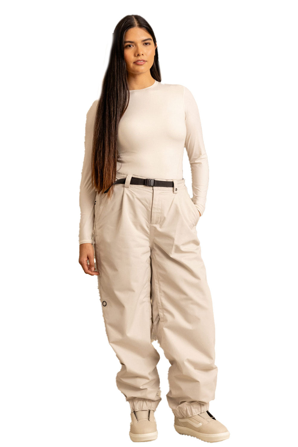 Woman wearing a beige jumpsuit on a white background