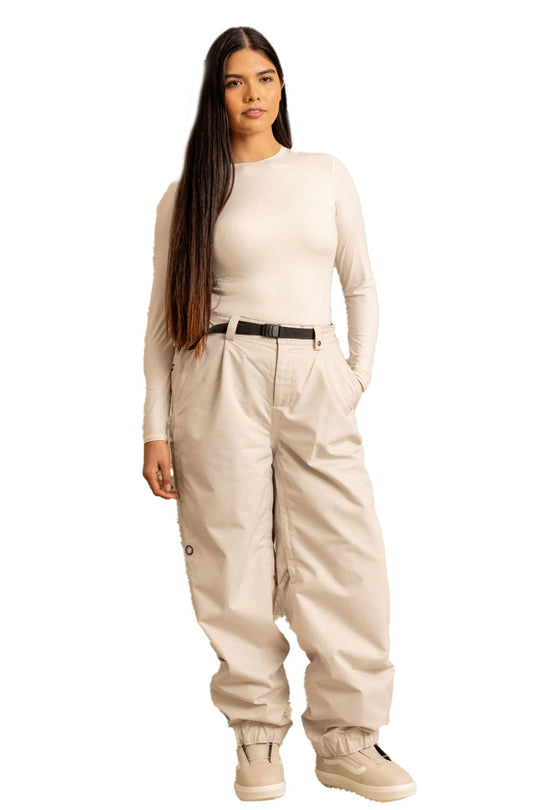 Woman wearing a beige jumpsuit on a white background