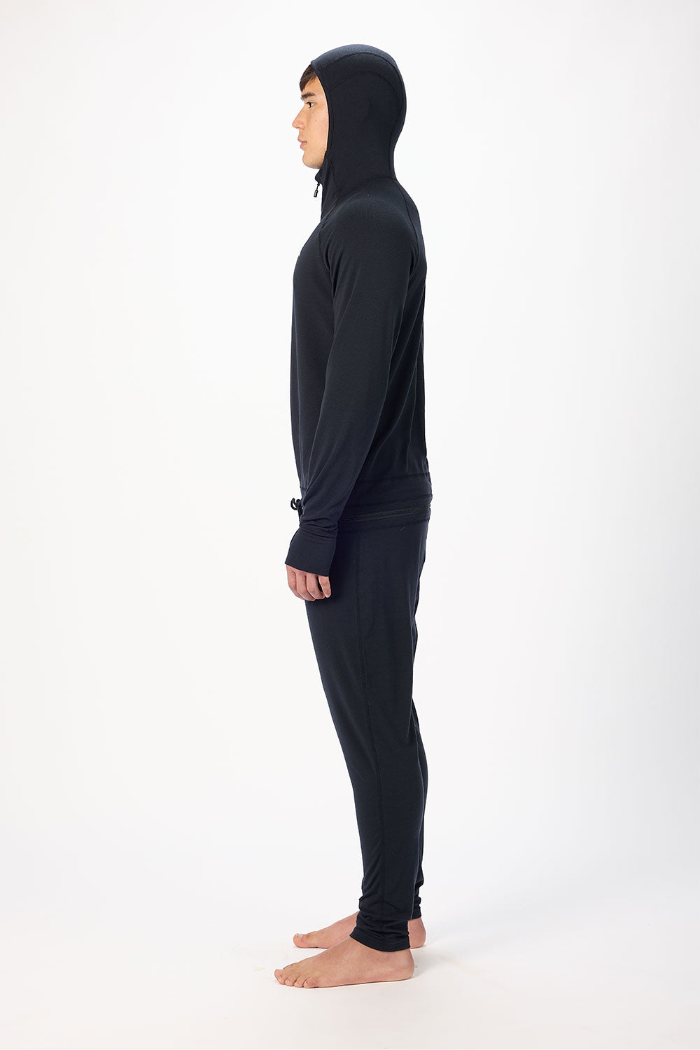 Person wearing a black full-body suit with a hood on a white background