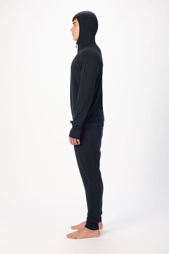 Person wearing a black full-body suit with a hood on a white background