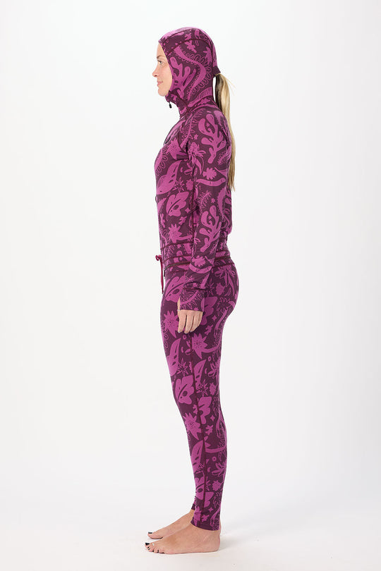 Person wearing a purple camouflage hoodie and pants on a white background