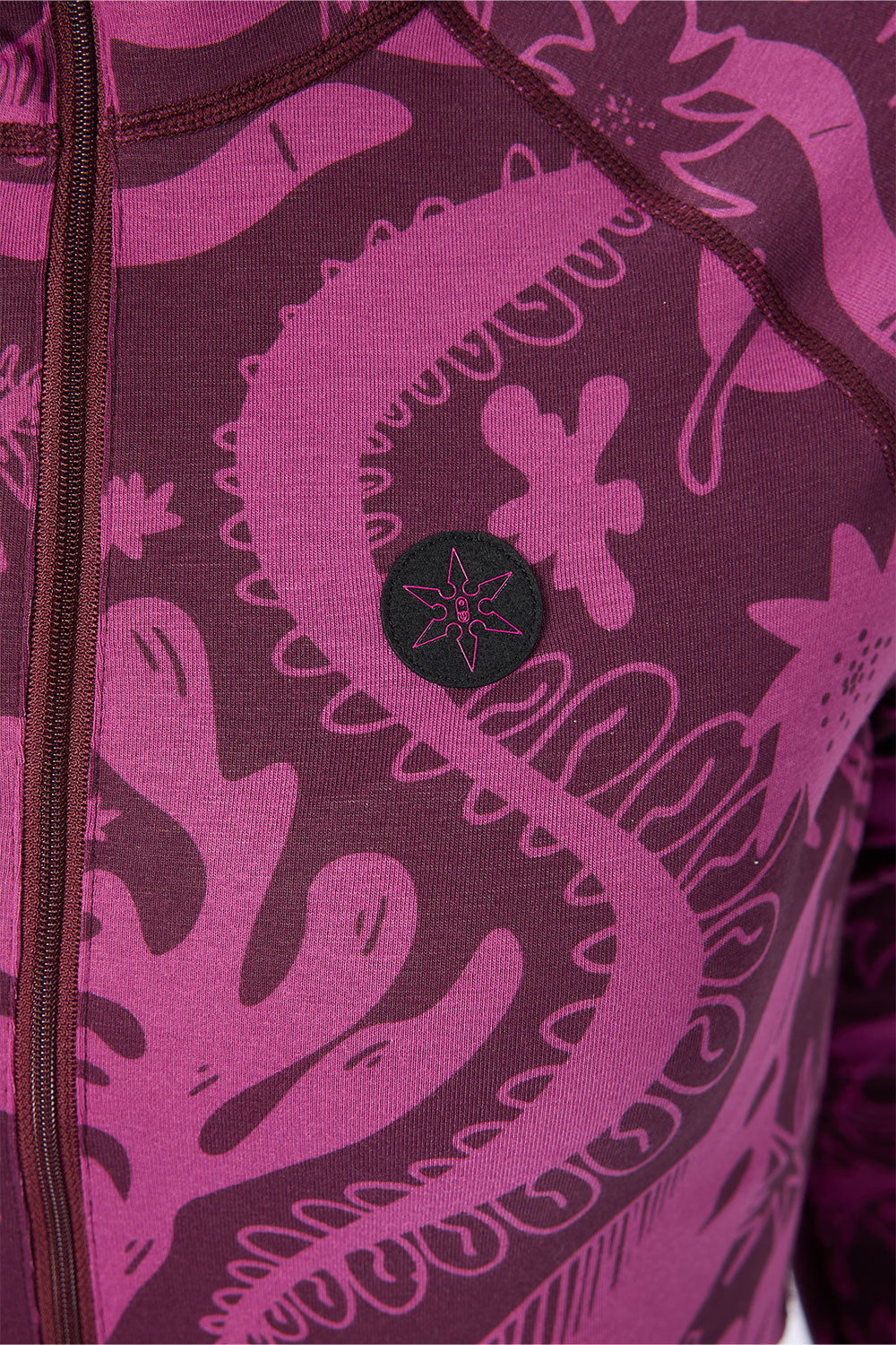 Close-up of a purple and black patterned garment with a star design on a white background