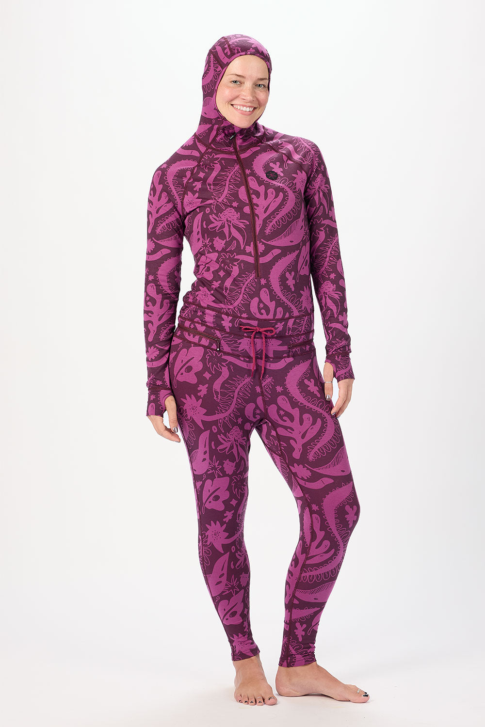 Person wearing a purple patterned full-body suit on a white background