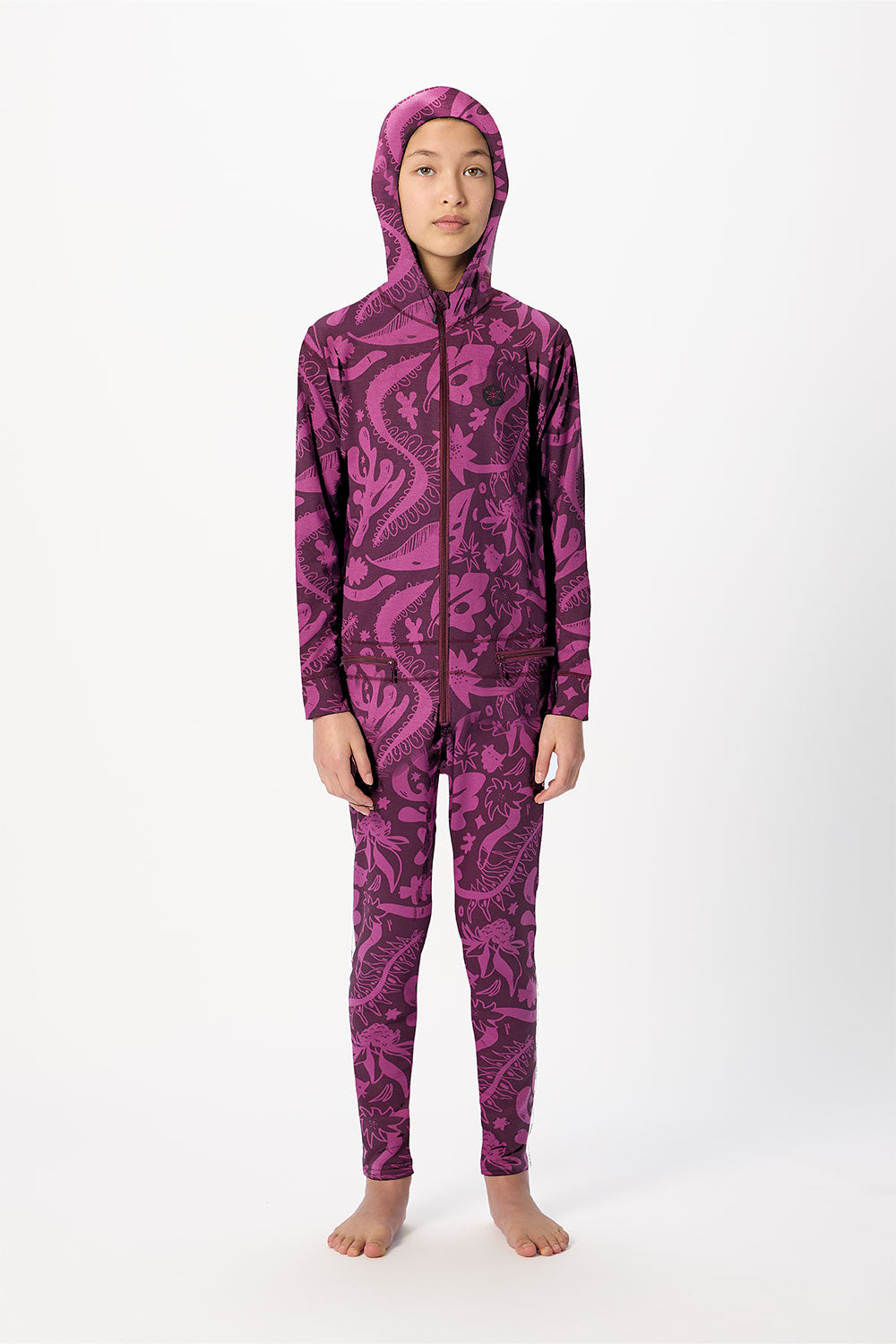 Person wearing a purple patterned onesie on a white background