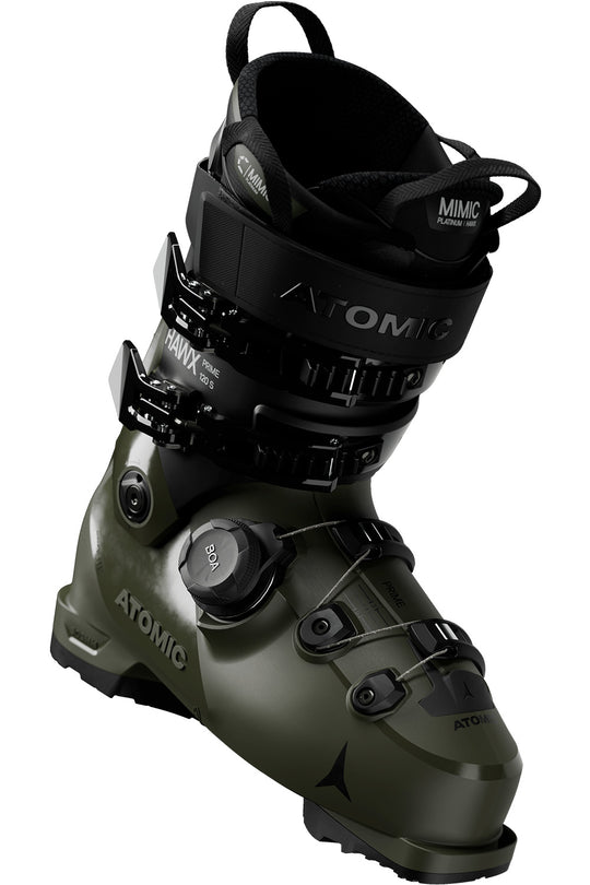 An Atomic ski boot in olive green and black, featuring the Atomic logo and dial closure system, shown on a plain white background.