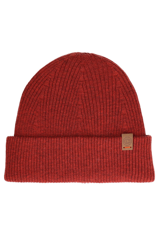 A red ribbed knit beanie hat with a folded cuff and a small tan leather brand patch on the side, shown against a plain white background.