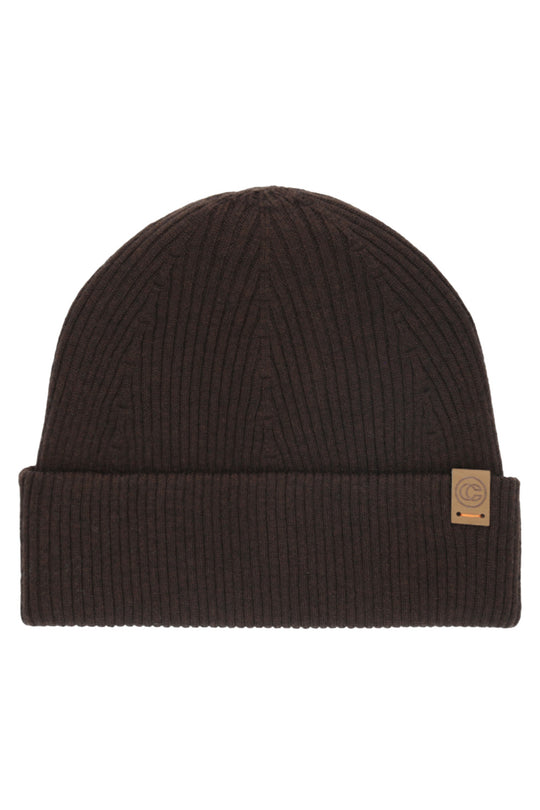 A dark brown ribbed knit beanie hat with a folded cuff and a small tan leather patch on the side, shown against a plain white background.