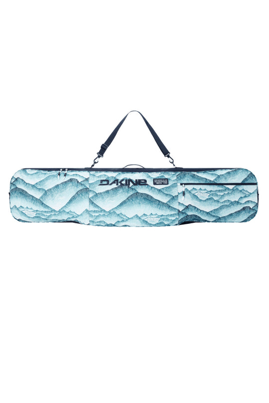 A Dakine snowboard bag featuring a blue and white mountain landscape print, with a black shoulder strap and the Dakine logo on the front.