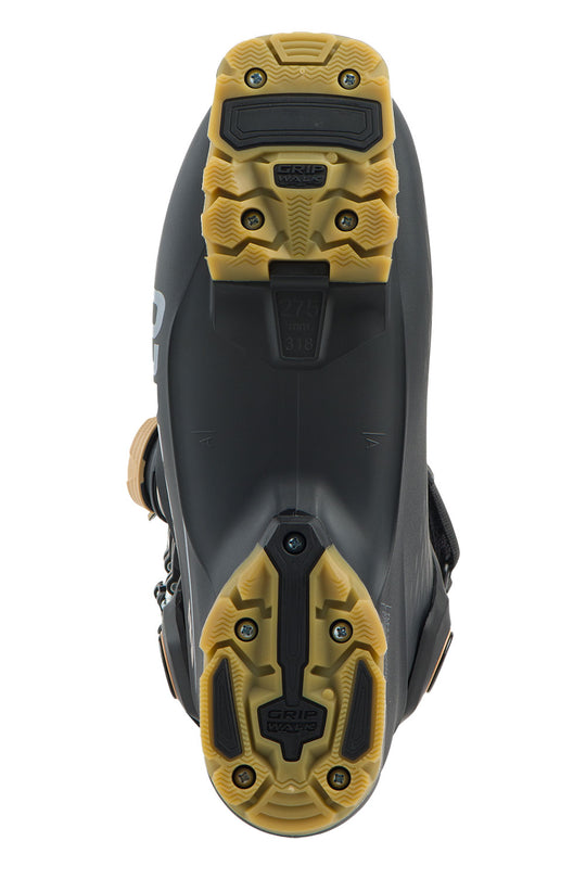Close-up of a black and yellow ski boot sole on a white background