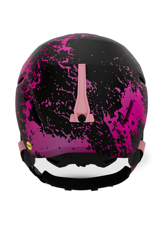 A ski helmet featuring a black and vibrant pink paint splatter pattern, with a matte pink central vent trim and a black chin strap, shown against a plain white background.
