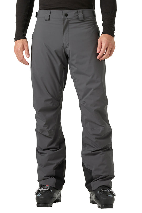 A person wearing dark gray ski pants with a black long-sleeve top and black ski boots, shown from the waist down against a plain white background.