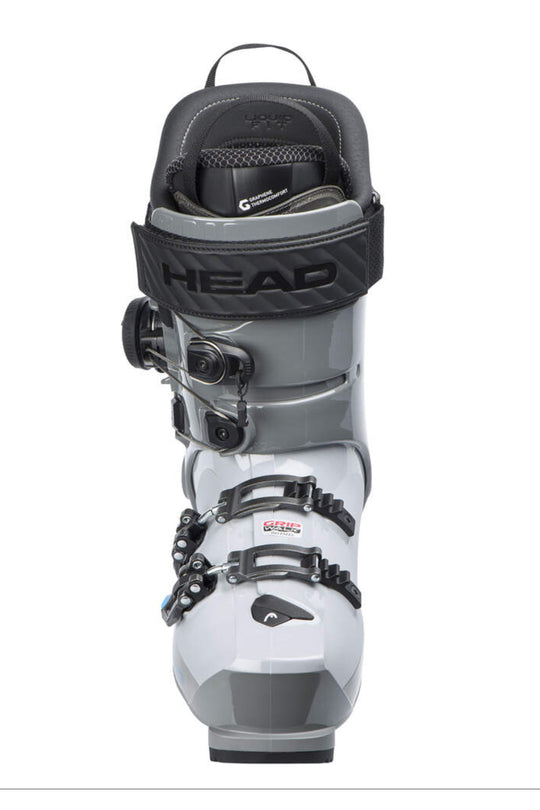 A single ski boot shown from the front on a plain white background. The boot is primarily light gray with black straps, buckles, and upper sections, plus a small red and white logo detail on one of the front straps.