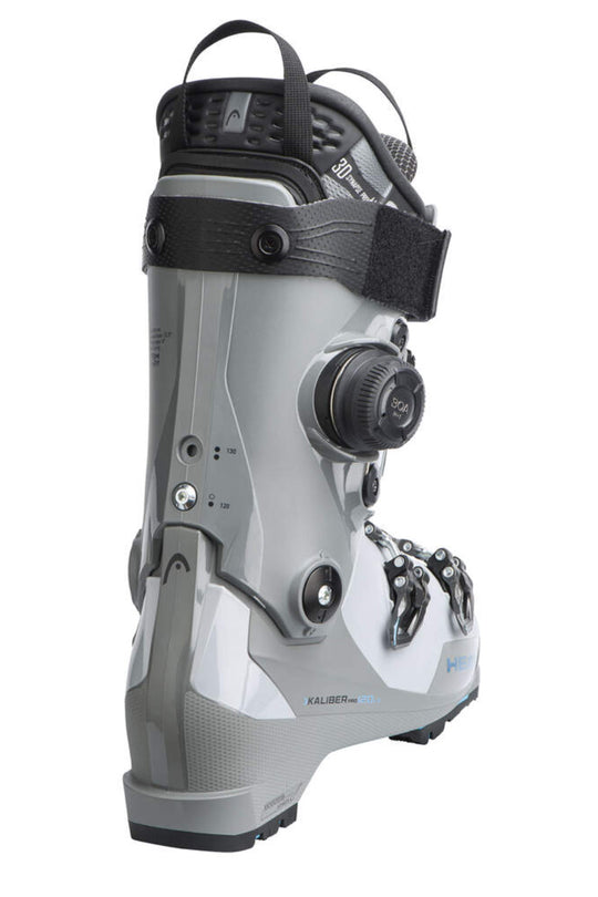 A ski boot in silver and black, shown from a side profile view against a plain white background.