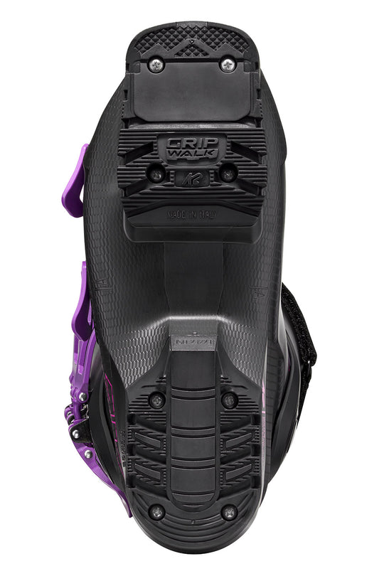 Close-up of a black and purple snowmobile boot sole with 'Grip Walk' branding on a white background.