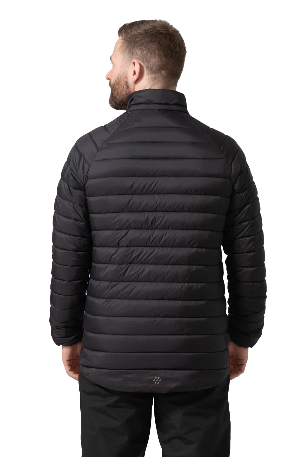 A man viewed from the back wearing a black horizontally quilted puffer jacket and black pants against a plain white background.