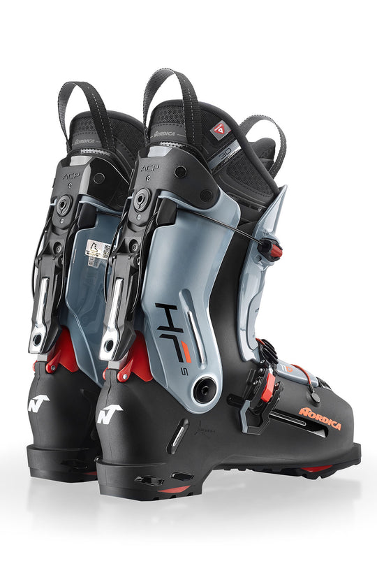 Pair of black and gray ski boots with visible branding on a white background