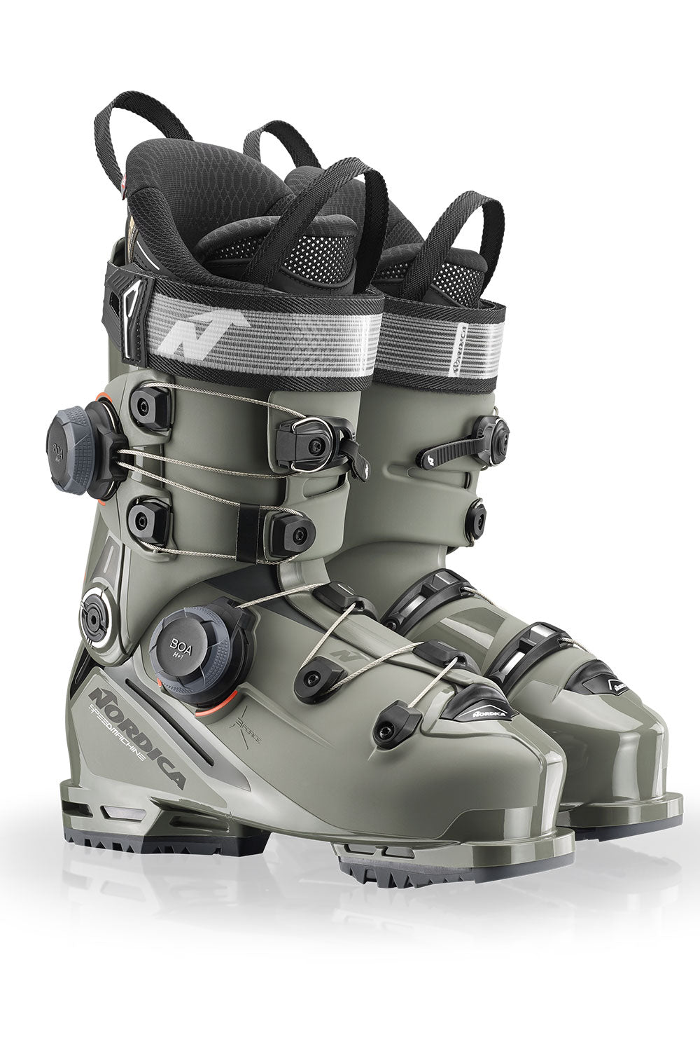 Pair of green ski boots with black straps on a white background