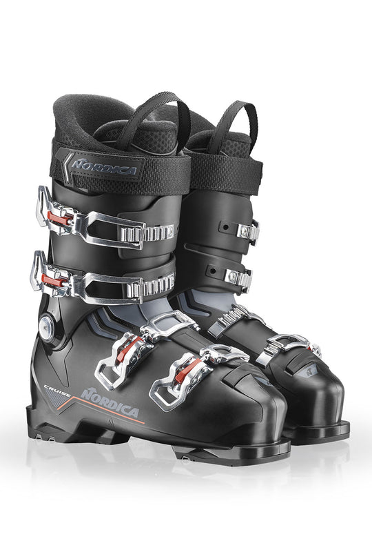 Black ski boots with silver buckles on a white background