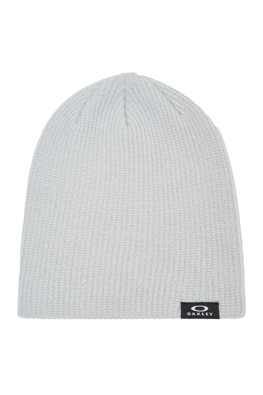 A light gray ribbed knit beanie hat with a small black Oakley logo patch on the lower right edge, shown against a plain white background.