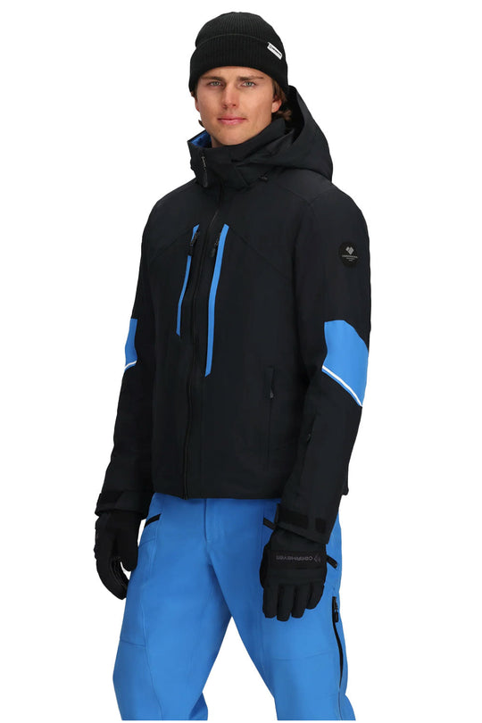 Person wearing a black and blue winter jacket with matching pants on a white background