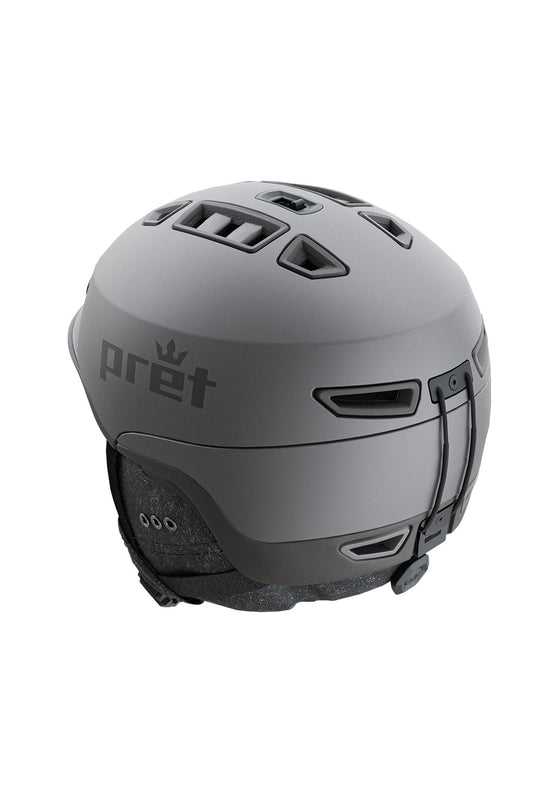 A matte dark gray ski helmet with the Pret brand logo printed on the side, shown from a three-quarters rear angle against a plain white background.