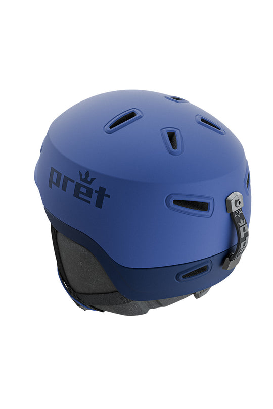 A matte blue ski helmet with the 'pret' brand name and crown logo on the side, shown from a three-quarters angle against a plain white background.