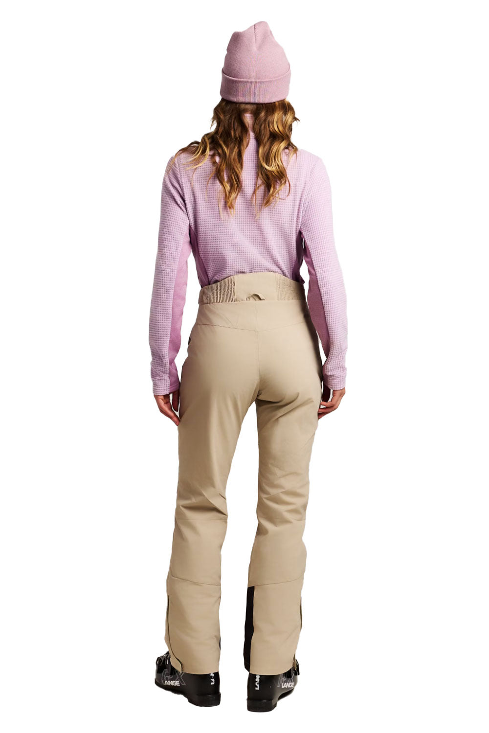 Person wearing a pink top and beige pants on a white background