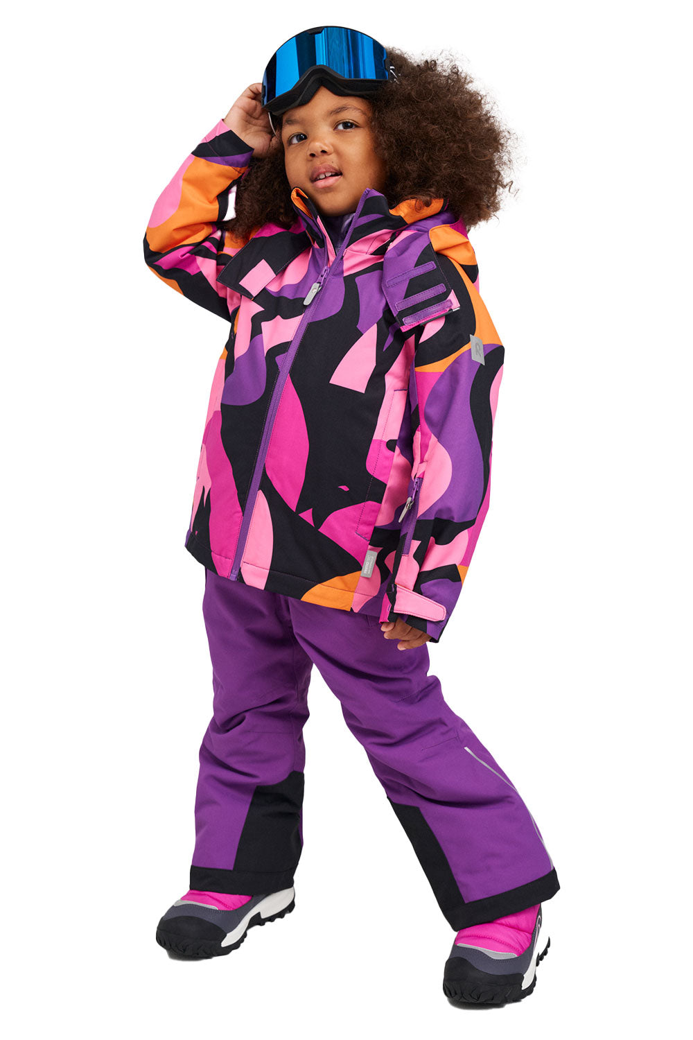 Child wearing a colorful ski suit with a purple base and pink and orange patterns on a white background
