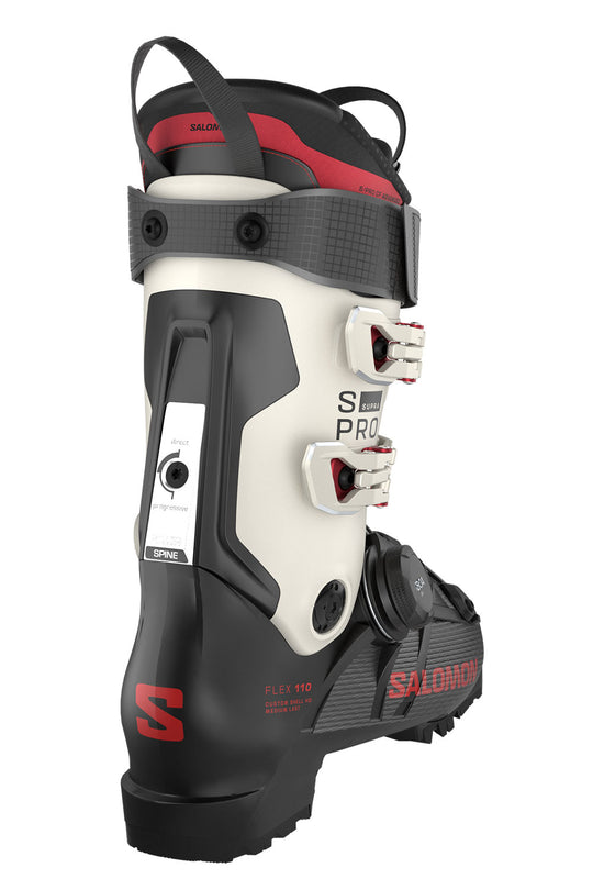 Salomon ski boot in white, black, and red, featuring dual buckle closures and a textured strap system, shown against a plain white background.