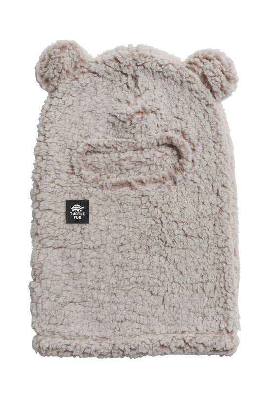 A light beige sherpa fleece beanie hat with bear ears on top and a small black 'TURTLE FUR' brand patch on the front, shown against a plain white background.