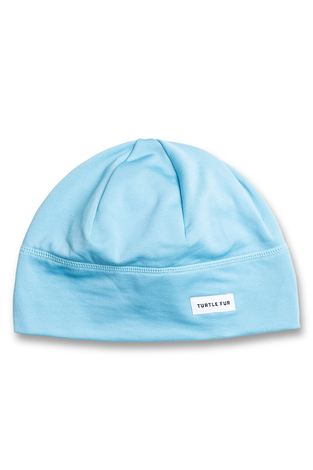 A light blue knit beanie hat with a small white rectangular label that reads 'TURTLE FUR' on the front, shown against a plain white background.