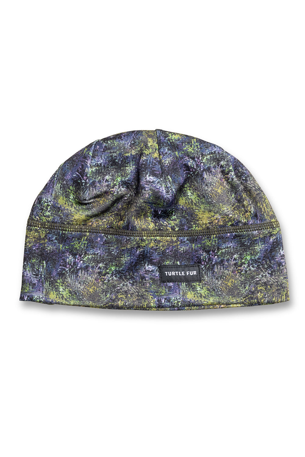 A flat-brim beanie hat featuring a textured, mottled camouflage pattern in dark blue, green, and yellow. A small black brand label reading 'TURTLE FUR' is stitched on the front center seam.